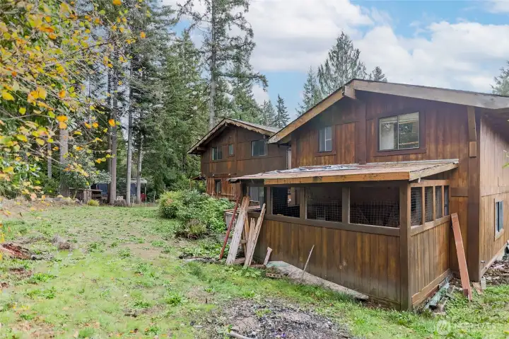 Back of garage on right with storage shed on back. Back of home in Center of Photo--so much potential for your Pacific Northwest Haven.