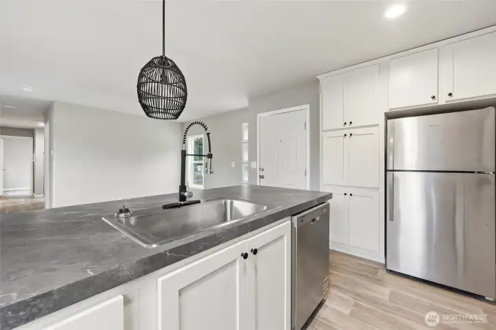 The home maximizes the storage in this space, lots of storage in this cabinet fridge surround.