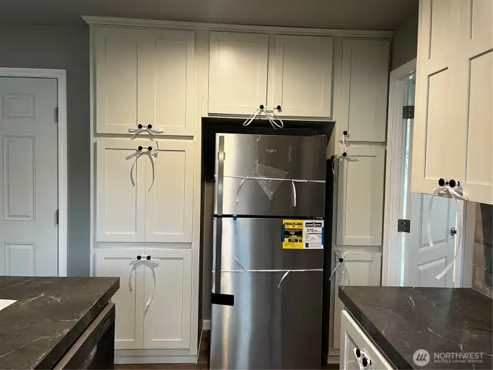 Lots of storage in this cabinet surround on the fridge.