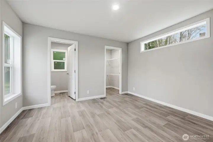 Primary bedroom with walk in closet and 3/4 bath