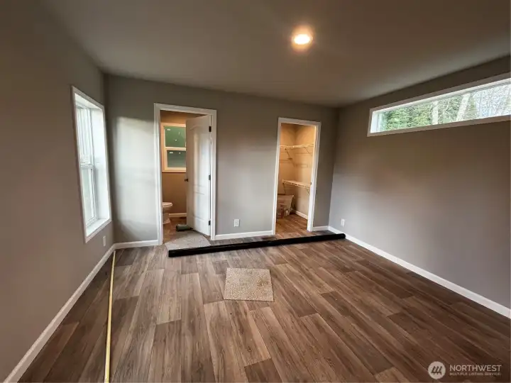 Primary bedroom with walk in closet and 3/4 bath