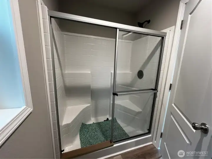 Both showers in the home have benches.