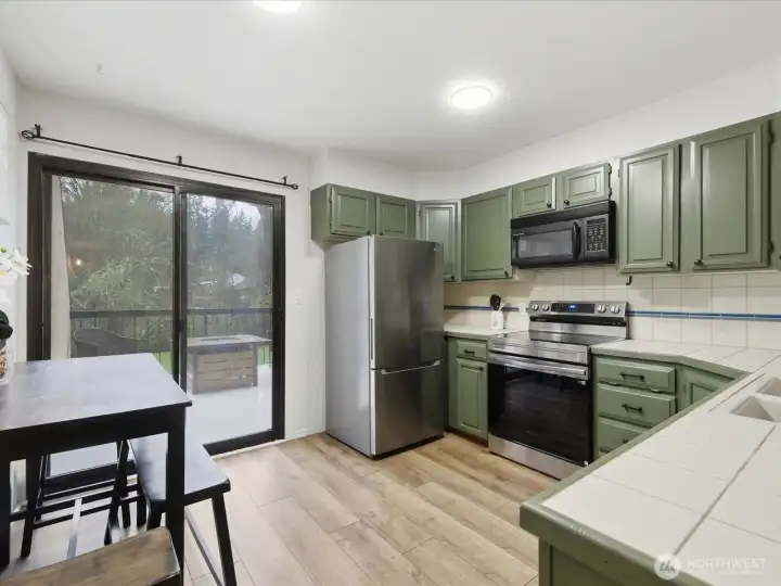 Kitchen with lots of natural light and some newer appliances