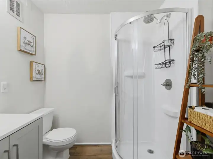 .75 bathroom with shower and storage room.