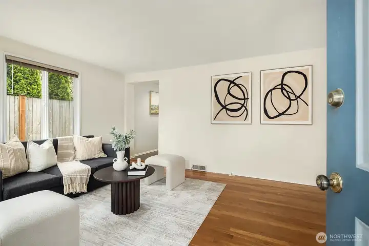 Light-filled living room with hardwood floors and staging Light-filled living room with hardwood floors and staging