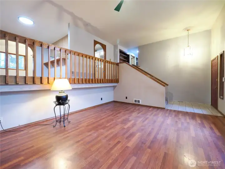 Living room with main entry on right, upper level with kitchen, dining room, formal dining or rec room, hallway leads to 3 bedrooms.