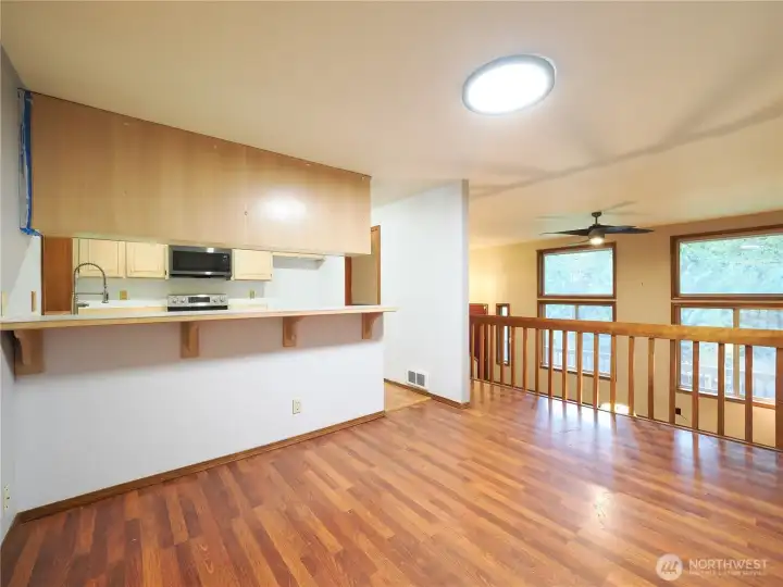 Casual dining with breakfast bar overlooks living room and kitchen