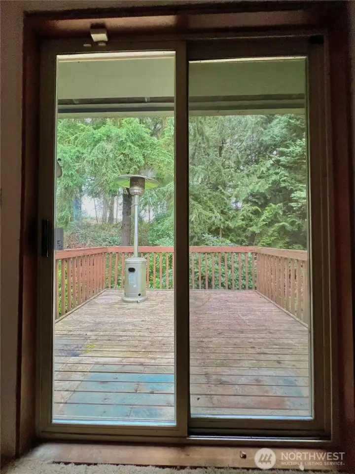 Sliding glass doors leads to secluded deck off the primary bedroom