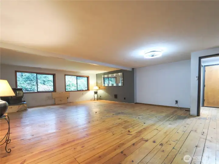 Custom wood planked flooring, large rec room, pellet stove.