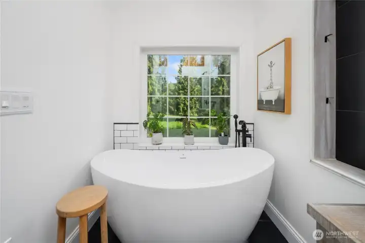 Elegant soak-in tub with views to the private backyard