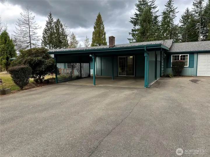 Large carport with single car enclosed garage