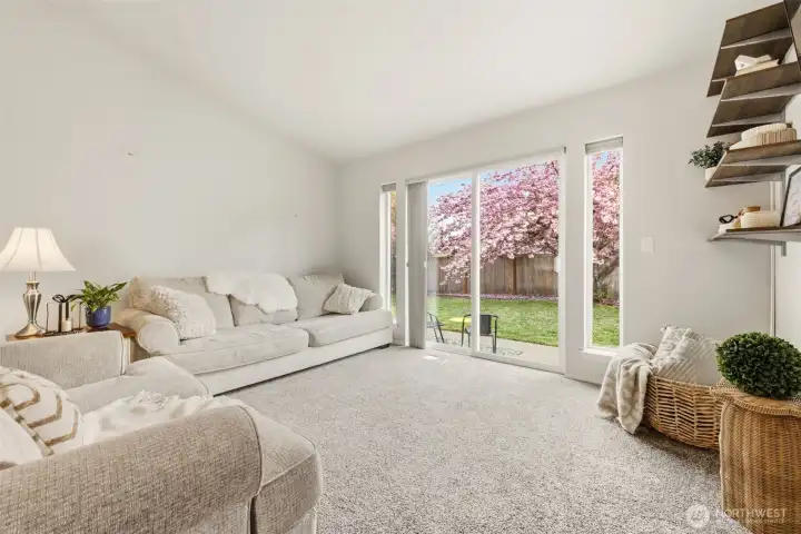 Living area looks out onto back patio and yard