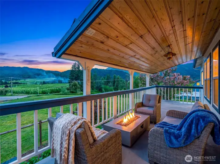 Covered decking invites year-round outdoor living, showcasing panoramic valley and mountain views in every direction. Warm tongue-and-groove wood ceilings add a refined mountain-lodge feel.  Virtually staged