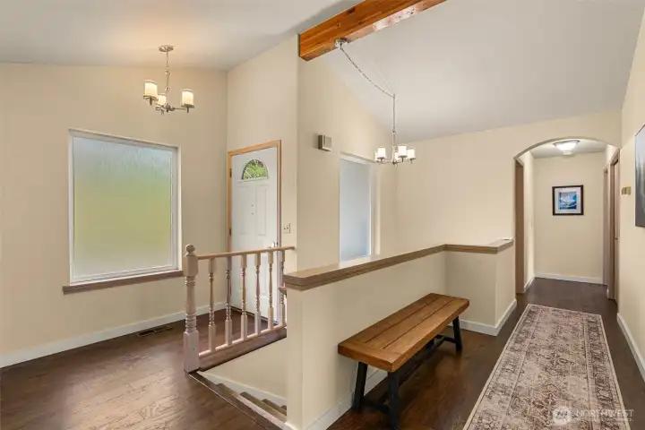 A welcoming entry foyer introduces the home with vaulted ceilings,