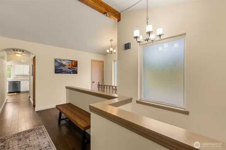 Large windows bring in natural light throughout the hallway and entry, enhancing the home’s bright and inviting atmosphere.
