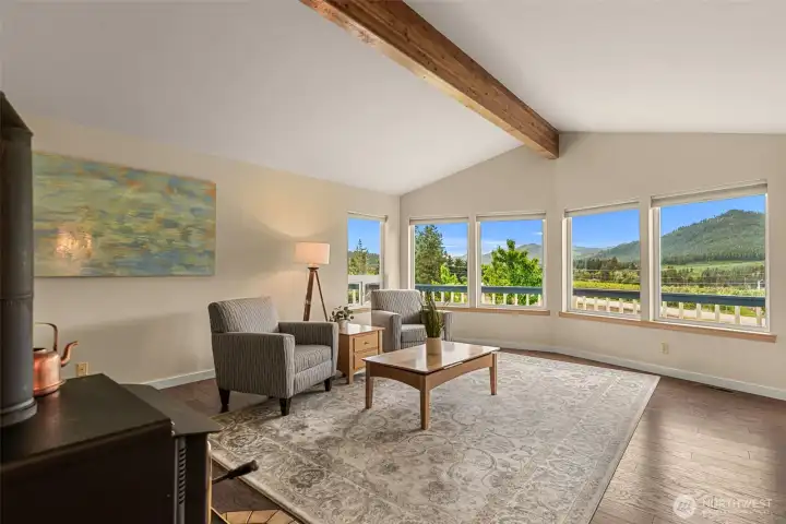 Vaulted ceilings and a warm exposed beam frame this light-filled living space,
