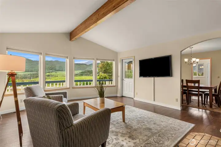 Large windows frame peaceful mountain and territorial views, while the open layout flows effortlessly into the adjacent dining area—ideal for both quiet evenings and entertaining.