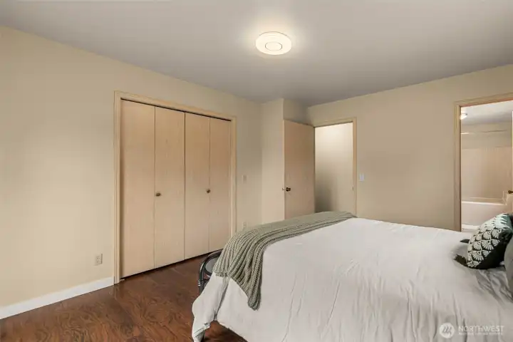The generous layout provides a relaxing retreat with warm  flooring and a seamless connection to the surrounding landscapePrimary bedroom