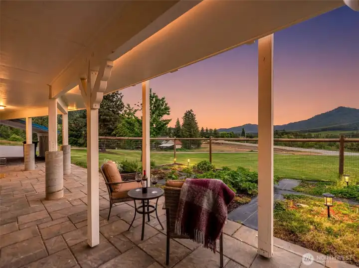 The covered patio creates an inviting extension of the home, perfectly positioned to capture peaceful sunset views across the surrounding mountains and valley.  Virtually staged