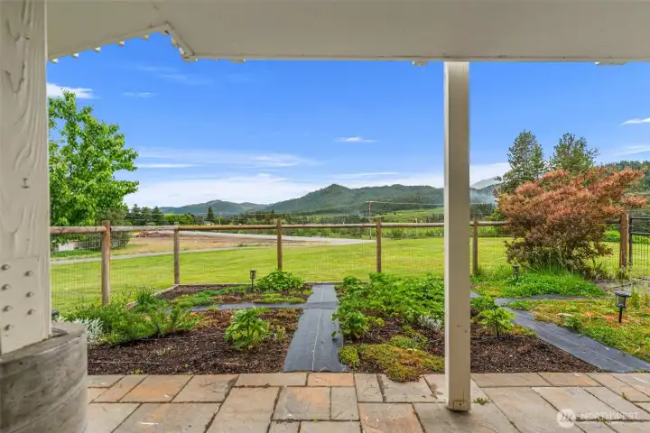 Enjoy unobstructed views of the surrounding mountains and open countryside from this covered outdoor living space, thoughtfully positioned to embrace the property’s peaceful setting.