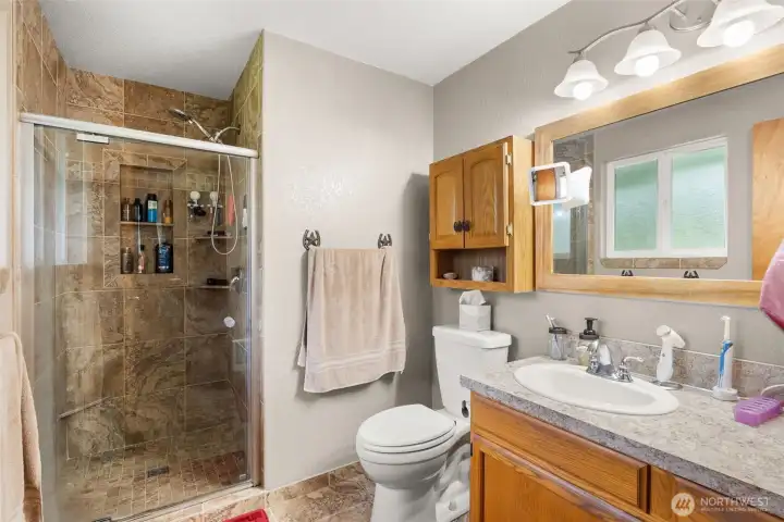 primary bathroom with tile shower
