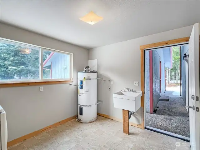 Separate heated laundry room with wash sink keeps the laundry out of sight & noise out of the home. Conveniently located with ample room for storage too!