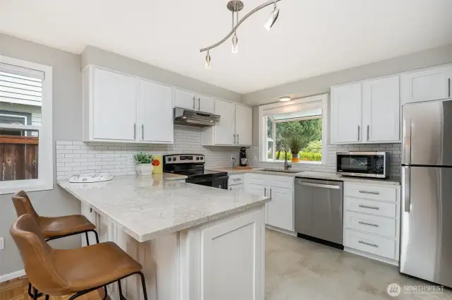 Upgrades include quartz counters, new flooring, soft close drawers & cabinets and new appliances.