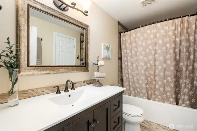 Beautifully updated full bath with soaking tub tile floors and tile shower