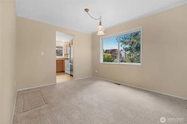 This area was used as a more formal dining room by the current sellers. That's the kitchen through the doorway.