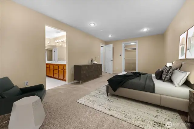 Sizeable primary has enough space for an office area - virtually staged.