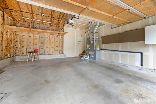 Spacious two-car garage with built-in storage shelving.