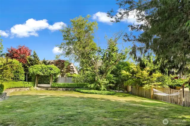Another view of the yard with mature landscaping.