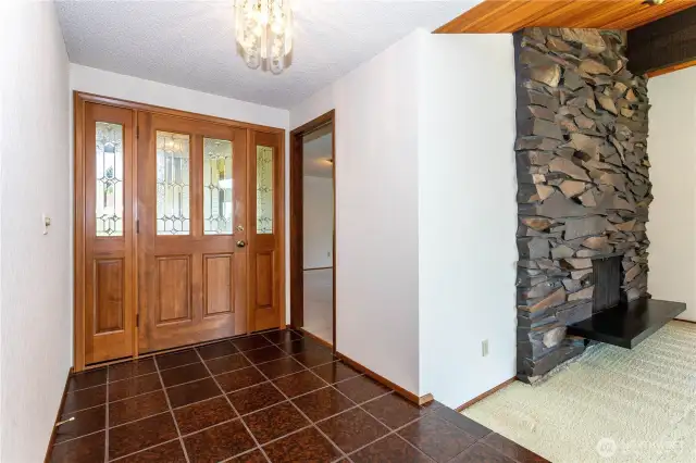 Wide foyer leads to family room & living room with floor to ceiling rockery