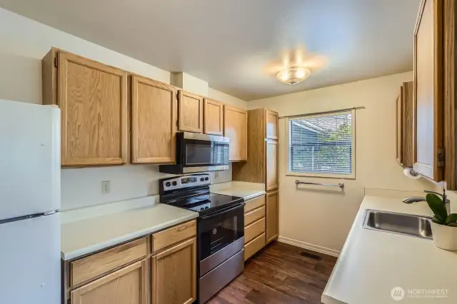 The kitchen features a brand new stainless steel oven/range and microwave.