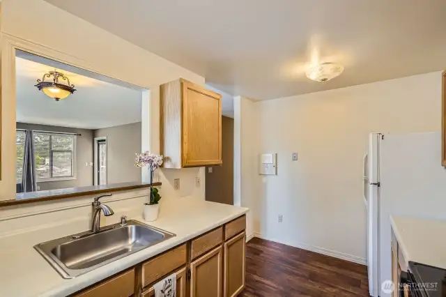 A large pass-through opening to the dining area is convenient for entertaining and conversing with your visitors.
