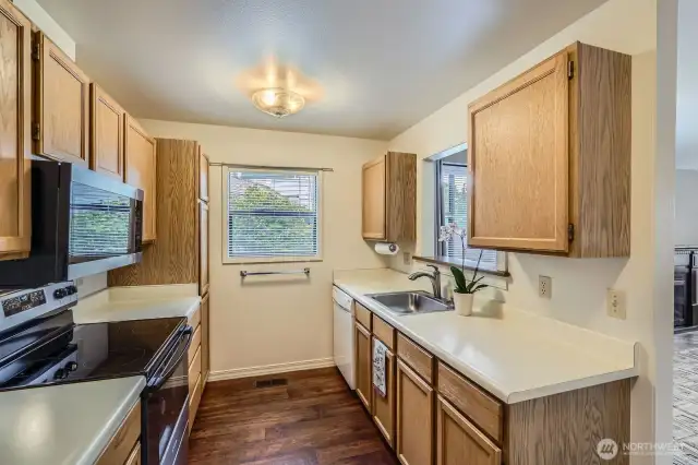 Being an end unit, extra light shines through the window and pass-through opening to the dining area.