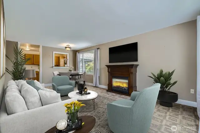 An attractive fireplace mantle and large windows that bring in the light are special features of this end unit. Virtually staged.