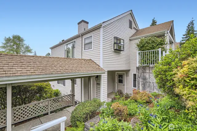 Beautiful landscaping welcomes you and your guests to the entryway of your new home.