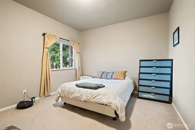 Second ensuite bedroom with full bath, walk in closet, and a water view.