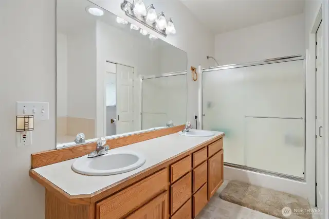 Dual Vanity's, soaking tub and a privy in the Primary