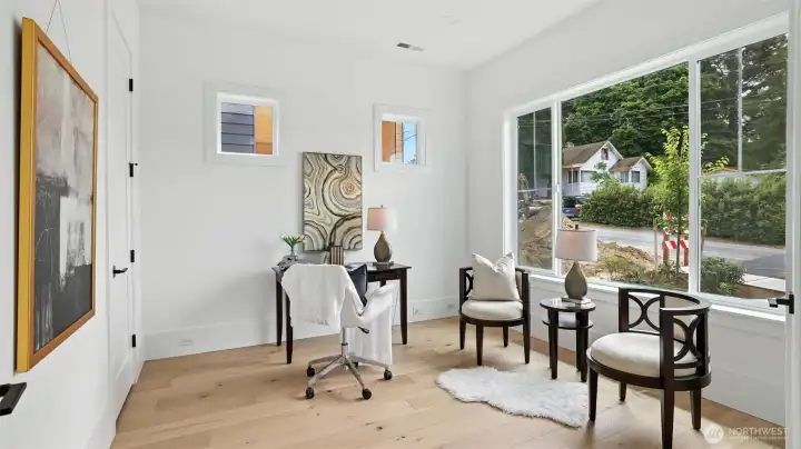 Main_Floor Den:  Tucked just off the entry, the den offers a quiet retreat for work or creativity. Framed by oversized windows that bring in natural light, this versatile space is ideal for a home office, study, or reading lounge. Thoughtful window placement provides privacy while maintaining connection to the surrounding landscape.  Large walk-in closet perfect for storing clutter – out of sight but readily accessible.