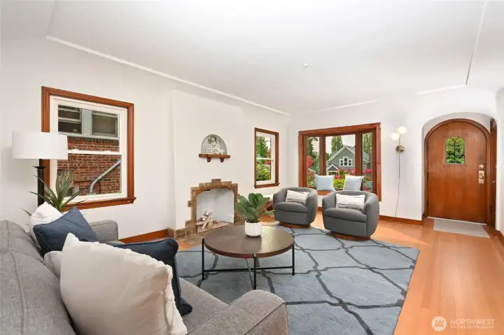 leads you into a spacious living room with a classic Batcheldor tile fireplace