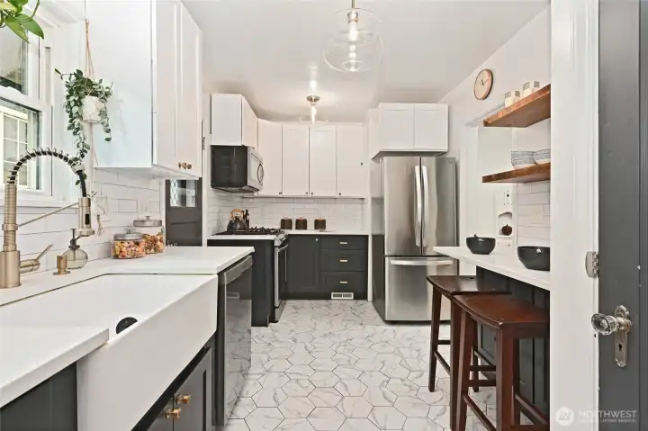 Recently remodeled kitchen with farmhouse sink and gas stove