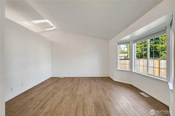 Vaulted ceiling and sunny windows for living