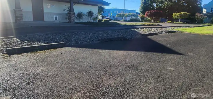 4 angled parking spots to the right, view of dental office next door