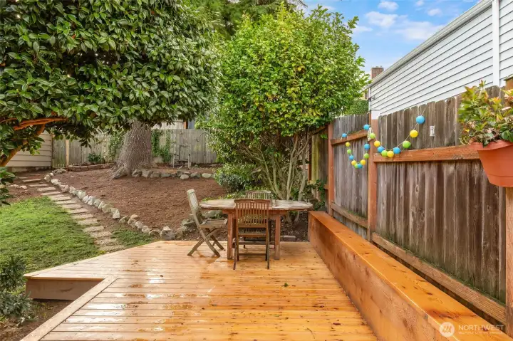 New deck wraps the North border of the home providing really easy access from back yard into kitchen and front door