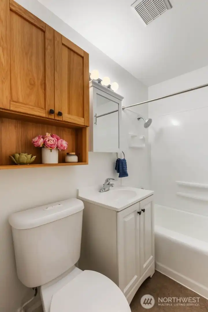 Full bathroom with of extra storage.