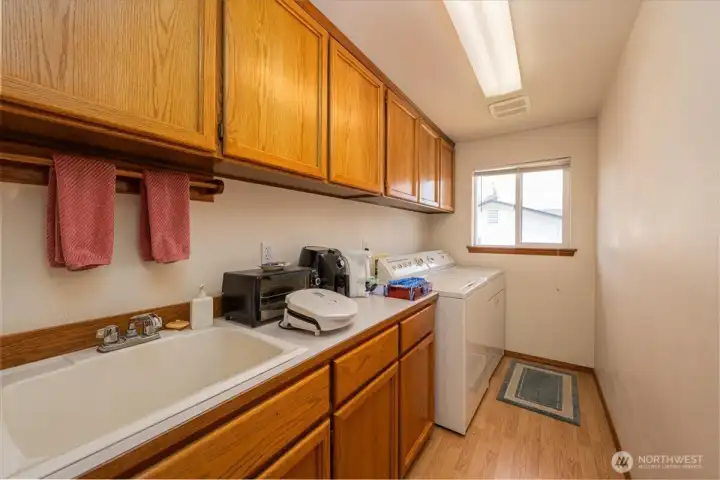 Laundry room with storage.