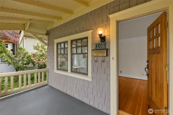 Beautifully preserved Greenwood Craftsman with wood floors and period details.