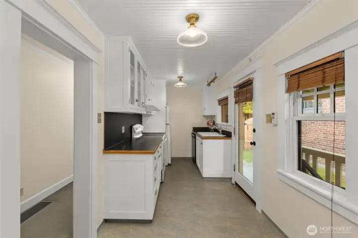 Kitchen faces west and the light is extraordinary. Door leads to covered porch and backyard filled with Bluebells, Dogwood and herbs.